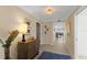 Bright condo hallway with elegant lighting, tiled floors, and access to various rooms at 11000 Placida Rd # 2702, Placida, FL 33946
