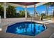 Community hot tub with clear blue water and view of palm trees and the American flag at 11000 Placida Rd # 2702, Placida, FL 33946