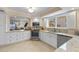Bright kitchen featuring granite countertops, stainless steel appliances, and white cabinetry at 11000 Placida Rd # 2702, Placida, FL 33946