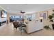 Cozy living room with a fireplace, comfortable seating, and scenic waterfront views at 11000 Placida Rd # 2702, Placida, FL 33946