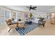 Bright living room featuring a white sectional sofa, brown leather chair, and modern patterned rug at 11000 Placida Rd # 2702, Placida, FL 33946