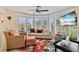 Comfortable living room bathed in natural light, features cozy seating, colorful decor and large windows at 11000 Placida Rd # 2702, Placida, FL 33946