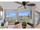 Enclosed patio with beautiful bay views, ceiling fan, and neutral decor with a tile floor at 11000 Placida Rd # 2702, Placida, FL 33946