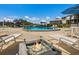 Beautiful outdoor pool area with a modern fire pit and plenty of seating for relaxation at 11000 Placida Rd # 2702, Placida, FL 33946