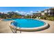 A beautiful blue swimming pool is surrounded by lounge chairs and lush landscaping at 11000 Placida Rd # 2702, Placida, FL 33946