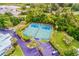 Aerial view of the tennis courts with lush landscaping, parking, and amenities in this beautiful community at 11000 Placida Rd # 2702, Placida, FL 33946