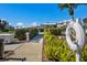 Well-maintained walkway leading to community amenities with manicured shrubs at 11000 Placida Rd # 2702, Placida, FL 33946