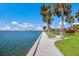 Scenic waterfront featuring grassy areas, mature palm trees and waterfront properties at 11000 Placida Rd # 2702, Placida, FL 33946