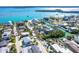 Stunning aerial view of home surrounded by lush landscaping and canals, near the beautiful blue ocean at 130 Sand Dollar Ln, Englewood, FL 34223