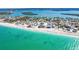 Stunning aerial view of beachfront homes with pristine sandy beach and turquoise ocean waters at 130 Sand Dollar Ln, Englewood, FL 34223