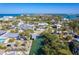 Beautiful aerial view of a bright beach house with mature landscaping and nearby canal access at 130 Sand Dollar Ln, Englewood, FL 34223