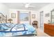 Bright bedroom with a blue turtle themed quilt, a ceiling fan, and a view to the outside at 130 Sand Dollar Ln, Englewood, FL 34223
