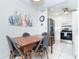 Dining area adjacent to kitchen, showcasing a wooden table with seating for four at 130 Sand Dollar Ln, Englewood, FL 34223