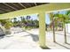 Exterior view of the home with palm trees and a white picket fence at 130 Sand Dollar Ln, Englewood, FL 34223