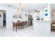 Eat-in kitchen with white cabinetry, stainless steel appliances, tile flooring and decorative accents at 130 Sand Dollar Ln, Englewood, FL 34223