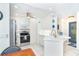 Bright kitchen featuring white cabinetry, stainless appliances, and a breakfast bar at 130 Sand Dollar Ln, Englewood, FL 34223