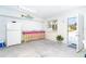 Kitchenette area with a sink, cabinets, refrigerator, and an exit door at 130 Sand Dollar Ln, Englewood, FL 34223