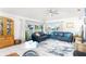 Spacious living room with comfortable seating, ceiling fan, and sliding doors to the outside at 130 Sand Dollar Ln, Englewood, FL 34223