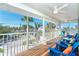 Screened-in porch with waterfront views and blue Adirondack chairs at 130 Sand Dollar Ln, Englewood, FL 34223