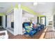 Relaxing porch with cozy seating, ceiling fans, and bi-fold doors to main living room at 130 Sand Dollar Ln, Englewood, FL 34223