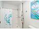 Shower with white shower curtain and decorative painting on the wall at 130 Sand Dollar Ln, Englewood, FL 34223