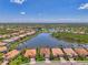 Expansive aerial view featuring lovely homes surrounding a large lake, reflecting a serene community ambiance at 13000 N Marsh Dr, Port Charlotte, FL 33953