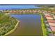 A serene aerial view of homes encircling a tranquil lake, creating a peaceful community setting at 13000 N Marsh Dr, Port Charlotte, FL 33953