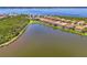 Scenic aerial view of lakeside homes with screened lanais, perfect for relaxing by the water at 13000 N Marsh Dr, Port Charlotte, FL 33953
