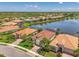 Lovely aerial showcases a community of well-maintained homes surrounding a peaceful lake at 13000 N Marsh Dr, Port Charlotte, FL 33953