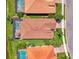 Birds-eye view shows a home with a screened pool, manicured landscaping, and tile roof at 13000 N Marsh Dr, Port Charlotte, FL 33953