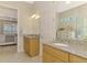 Dual sink bathroom featuring granite countertops, tiled floors, walk-in shower, and vanity cabinet storage at 13000 N Marsh Dr, Port Charlotte, FL 33953