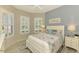 Cozy bedroom with shuttered windows, a ceiling fan and coastal decor at 13000 N Marsh Dr, Port Charlotte, FL 33953