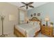 Inviting bedroom with seashell decorations features an ornamental ceiling fan and natural light for relaxation at 13000 N Marsh Dr, Port Charlotte, FL 33953