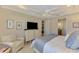 Relaxing bedroom featuring light wood floors, a large dresser, and a comfortable sitting chair for relaxation at 13000 N Marsh Dr, Port Charlotte, FL 33953