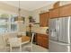 Bright breakfast nook with cabinetry, wine cooler, stainless refrigerator, and a serene view at 13000 N Marsh Dr, Port Charlotte, FL 33953