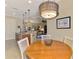 Open dining area with views to the kitchen, living room and stylish pendant lighting fixture at 13000 N Marsh Dr, Port Charlotte, FL 33953