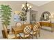 Traditional dining room boasts an elegant chandelier, wooden table, and lattice back chairs at 13000 N Marsh Dr, Port Charlotte, FL 33953