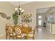 Dining room with tile floors, chandelier, dining table, and views of the front entrance at 13000 N Marsh Dr, Port Charlotte, FL 33953