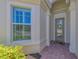 Charming front entrance with decorative door and window and brick paver entry at 13000 N Marsh Dr, Port Charlotte, FL 33953