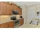 Well-equipped kitchen featuring stainless steel appliances, granite countertops, and warm wood cabinetry at 13000 N Marsh Dr, Port Charlotte, FL 33953