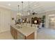 Open-concept kitchen island featuring bar seating, double sink, and stylish pendant lighting at 13000 N Marsh Dr, Port Charlotte, FL 33953