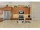 Kitchen boasts stainless steel appliances, wood cabinets, granite countertops, and island with seating at 13000 N Marsh Dr, Port Charlotte, FL 33953
