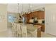 Spacious kitchen with stainless steel appliances, wood cabinets, granite countertops, and breakfast bar at 13000 N Marsh Dr, Port Charlotte, FL 33953