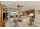 Bright, open living room with ceiling fan and water views from sliding glass doors at 13000 N Marsh Dr, Port Charlotte, FL 33953
