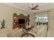 Living room boasts coffered ceiling and sliding doors that lead to a screened lanai and water views at 13000 N Marsh Dr, Port Charlotte, FL 33953