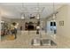 Spacious living room with coffered ceiling, fan, and seamless flow to the dining and kitchen areas at 13000 N Marsh Dr, Port Charlotte, FL 33953
