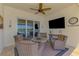 Screened-in patio overlooking a lake with comfortable seating and outdoor television at 13000 N Marsh Dr, Port Charlotte, FL 33953