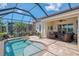 Screened pool and lanai with brick pavers offer lake views at 13000 N Marsh Dr, Port Charlotte, FL 33953