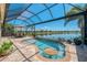Inviting screened pool and covered lanai overlooking the lake at 13000 N Marsh Dr, Port Charlotte, FL 33953
