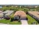 Aerial view showcasing a well-maintained single-story home with a red tile roof and lush green lawn at 13217 Scrub Jay Ct, Port Charlotte, FL 33953